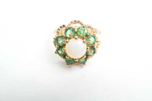 A vintage emerald and opal cluster ring in 9ct yellow gold.