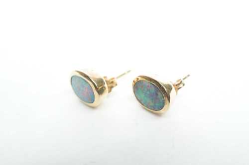 A pair of doublet opal stud earrings in 9ct yellow gold.