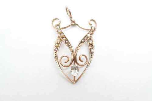 An antique seed pearl and aquamarine pendant in 9ct yellow gold.