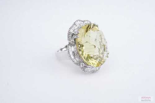 A lemon quartz and diamond cocktail ring in 18ct yellow gold.