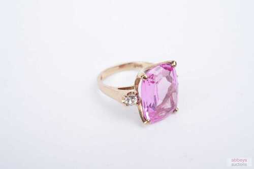 A synthetic pink sapphire and white topaz ring in 9ct yellow gold.