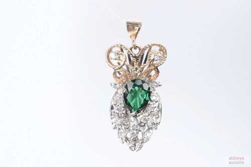 A diamond and dark green topaz pendant in 9ct yellow gold.