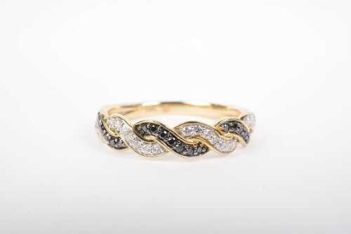 A black and white diamond twist ring in 9ct yellow gold.