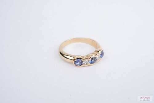 A Ceylon sapphire and diamond ring in 18ct yellow gold.