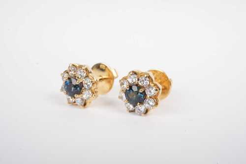 A pair of teal blue sapphire and cubic zirconia cluster earrings in 18ct yellow gold.