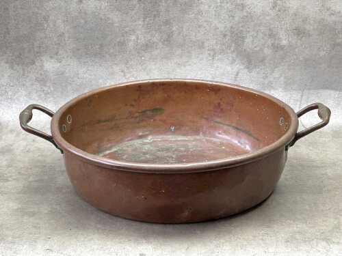 An antique copper twin handled pot