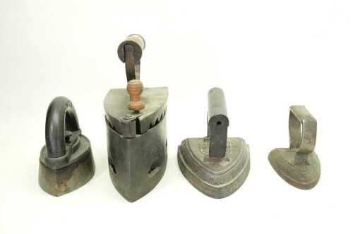 Four antique cast iron irons