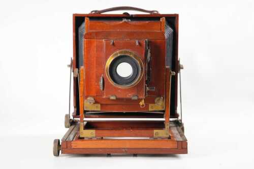 An antique Thornton-Pickard mahogany half-plate field camera, has Thornton-Pickard-Beck lens and roller blind shutter