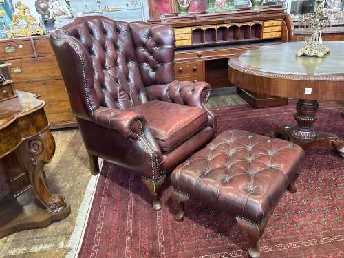 A Gascoigne button back leather wingback armchair & footstool