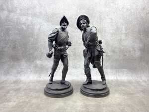 Pair of antique cast spelter musketeer statues