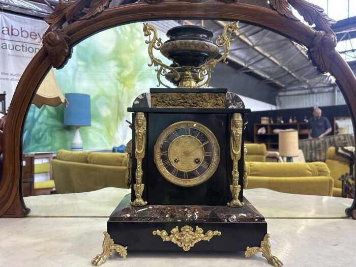An antique French slate mantel clock with gilt mounts