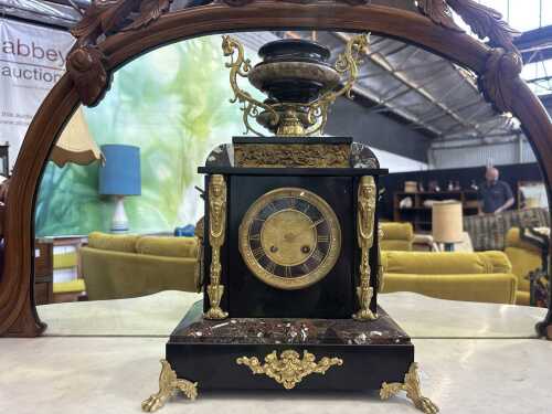An antique French slate mantel clock with gilt mounts