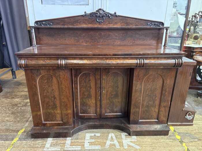 An Early Victorian flame mahogany breakfront sideboard