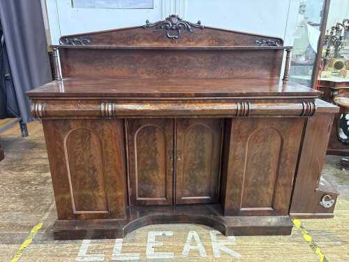 An Early Victorian flame mahogany breakfront sideboard