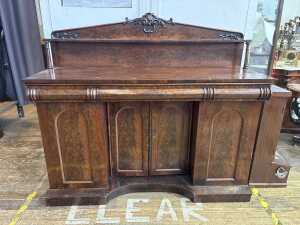 An Early Victorian flame mahogany breakfront sideboard