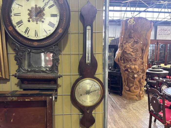 An antique mercury dial barometer with rosewood case.