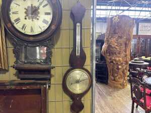 An antique mercury dial barometer with rosewood case.