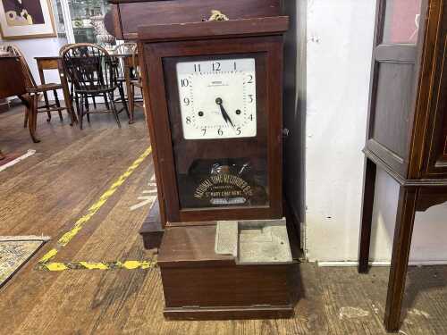 An antique National time clock