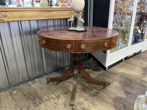 An antique mahogany drum table, early 20th century