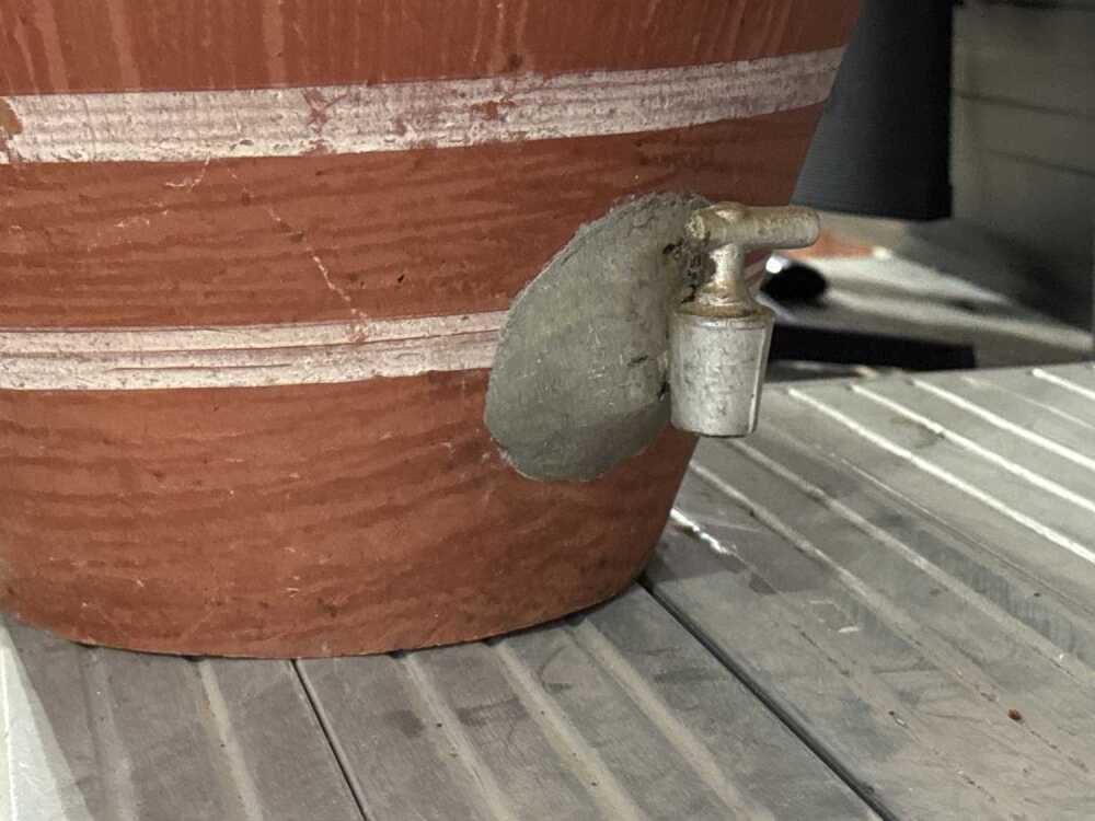 Unglazed terra cotta tapayan jar water dispenser
