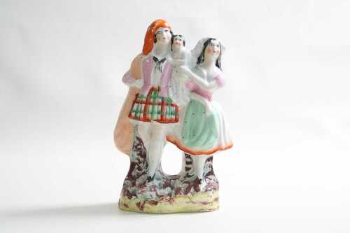 A Staffordshire ceramic figure of couple and child