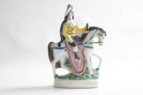 A Staffordshire Tom Pearce ceramic figure