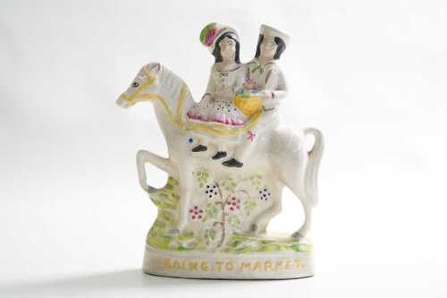 A reproduction Staffordshire Going to Market ceramic figure