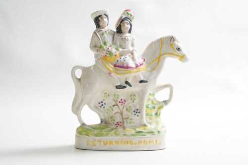 A reproduction Staffordshire Returning Home ceramic figure