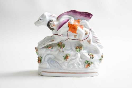 A Staffordshire ceramic figure of person riding horse