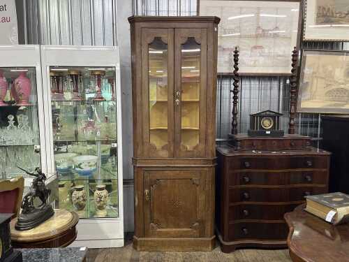 A Georgian oak corner cabinet