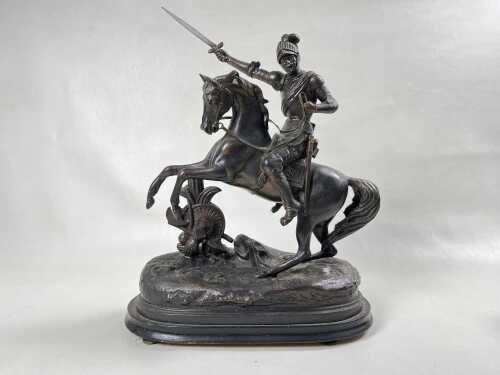 An antique bronzed spelter figure of knight on horseback