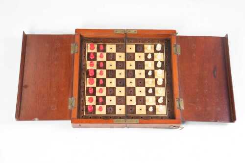 Antique mahogany cased travelling chess set