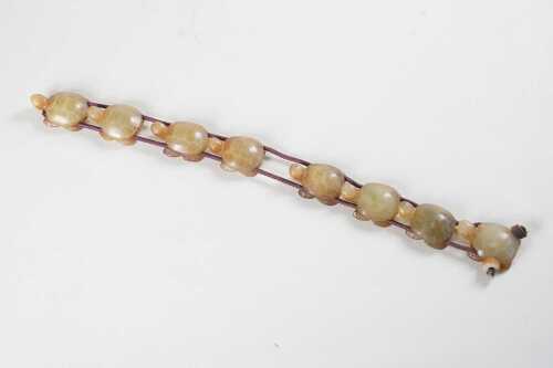 Strand of eight carved jade turtles