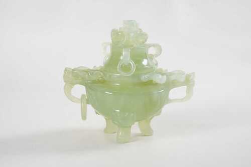 A carved jade lidded incense burner with dragon handles and lid