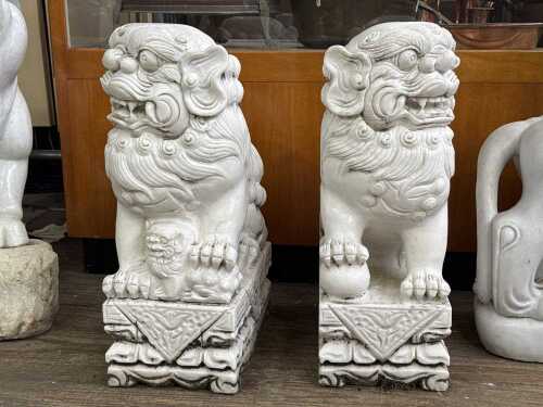 Pair of carved marble foo dog statues