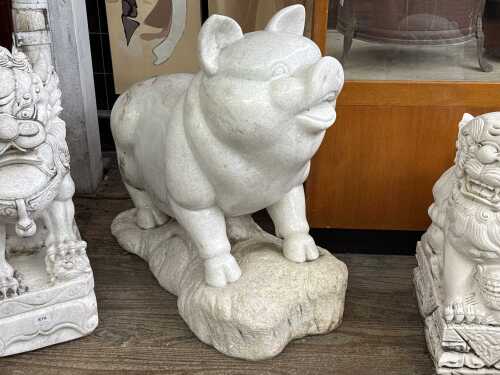 A large carved marble pig statue