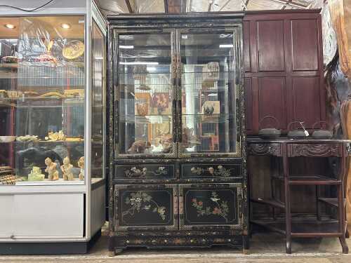 An Oriental black lacquer display cabinet
