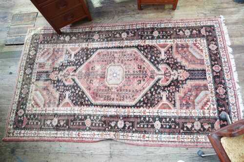 A Persian hand knotted wool rug
