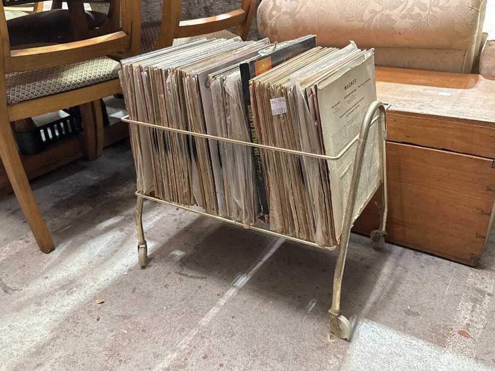 Portable mid-century metal record rack with assorted records